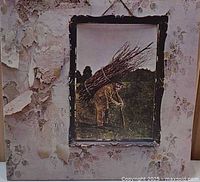 Front cover showing man with sticks, peeling wallpaper design