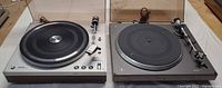 Both Philips turntables with dust covers open
