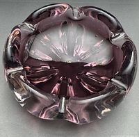 Angled view of amethyst glass bowl/ashtray showing scalloped rim and overall form