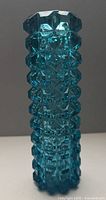 Front view of turquoise pressed glass vase
