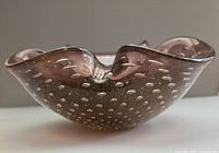Side profile of bronze Murano bowl showing controlled bubbles and wavy rim