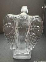 Rear view of frosted glass eagle on base