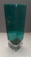 Angled view showing full height and thick clear base of emerald green bud vase