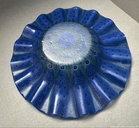 Top view of blue ruffled Higgins glass bowl showing overall form and color
