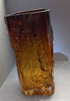 Full view of vase showing textured amber glass and square rim
