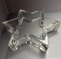 Oblique view of crystal star dish showing serrated edge and transparency