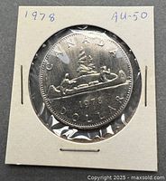 1978 Canada Voyageur dollar in flip, AU-50 notation visible