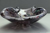 Angled side view of Murano Tutti Frutti bowl showing silver fleck and freeform rim