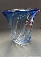 Oblique side view showing blue-to-clear gradient and twisted form