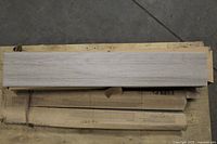 Boxed porcelain tile planks showing wood-look surface