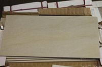 Top view of single beige porcelain tile removed from box