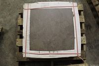 Top view of single 24" x 24" brown porcelain tile on pallet