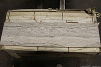 Single 12×48 silver polished porcelain tile on top of pallet