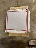 Top view of strapped bundle of square tiles on pallet
