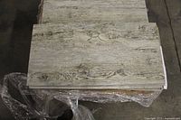 Stack of 12x24 porcelain tiles showing wood-grain surface