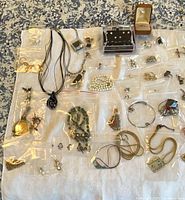Overview of all bagged jewelry items on cloth
