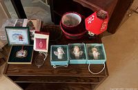 Overall lot view showing ornaments in boxes, lantern, baskets, cards