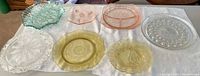 All seven pressed glass pieces displayed on cloth