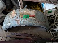 Stacked galvanized round fender showing overall size, adhesive residue, pre-drilled holes