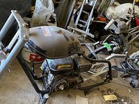 Overall view of mini bike frame with engine and loose parts