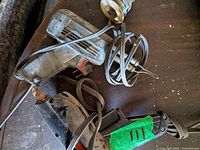 Glue gun, soldering gun and wire coil on table