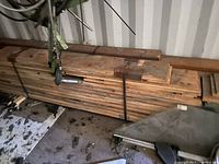 Strapped bundle of long tongue-and-groove boards on floor