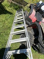 Full length view of aluminum ladder on ground beside ATV