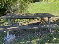 Full view of wooden 8-ft picnic table with benches
