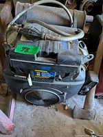 Front view showing Power Fist label, fan guard, hoses and wiring