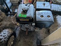 Top view of Powerfist 13 HP OHV engine showing fuel tank, recoil starter, electric starter and rusted horizontal output shaft