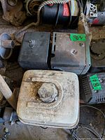 Top view showing engine with white fuel tank, pull-start housing, general wear