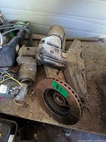 Overview of transom bracket, rotor, motor and housing on workbench