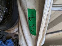 Close-up of canvas edge with zipper and taped width marking