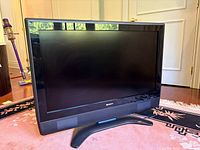 Front view of Sharp AQUOS 37-inch LCD TV on stand