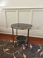 Full view of side table showing chrome frame and black tops
