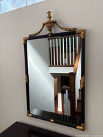 Full view of mirror showing frame, gold accents, and crest