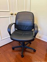 Front view of black leather swivel office chair