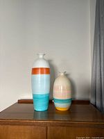 Both vases side by side on wooden surface