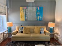 Both lamps displayed on side tables flanking sofa