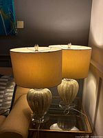 Both lamps illuminated on side table