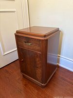 Full view of cabinet angled showing drawer, door, ribbed corners