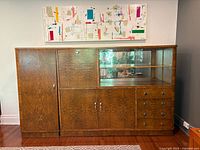 Front view of full cabinet showing veneer pattern, glass display, drawers and doors