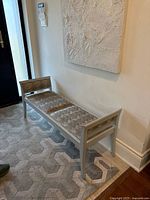 Full view of bench against wall showing overall design, colour and cushion fabric