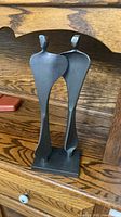 Front view of abstract embracing couple sculpture on wooden shelf