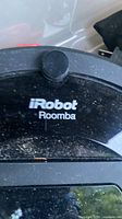 Close-up of iRobot Roomba branding on top surface