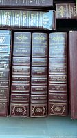 Three volumes upright showing gilt spine titles and motifs