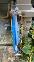 Graphic side of Sector 9 pintail longboard showing beach artwork, trucks and wheels