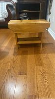 Full view of solid pine stool showing top and shelf