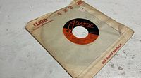 Front view of 7-inch record partially in WEA sleeve, Atlantic label visible