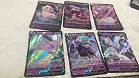 Six Pokémon V foil cards laid out showing fronts